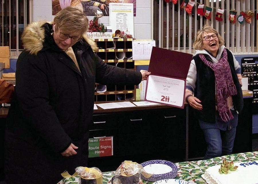  Photo of Barb Dahl being handed a certificate honoring her years of service