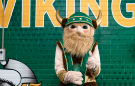 Victor Viking stands in front of viking mural 